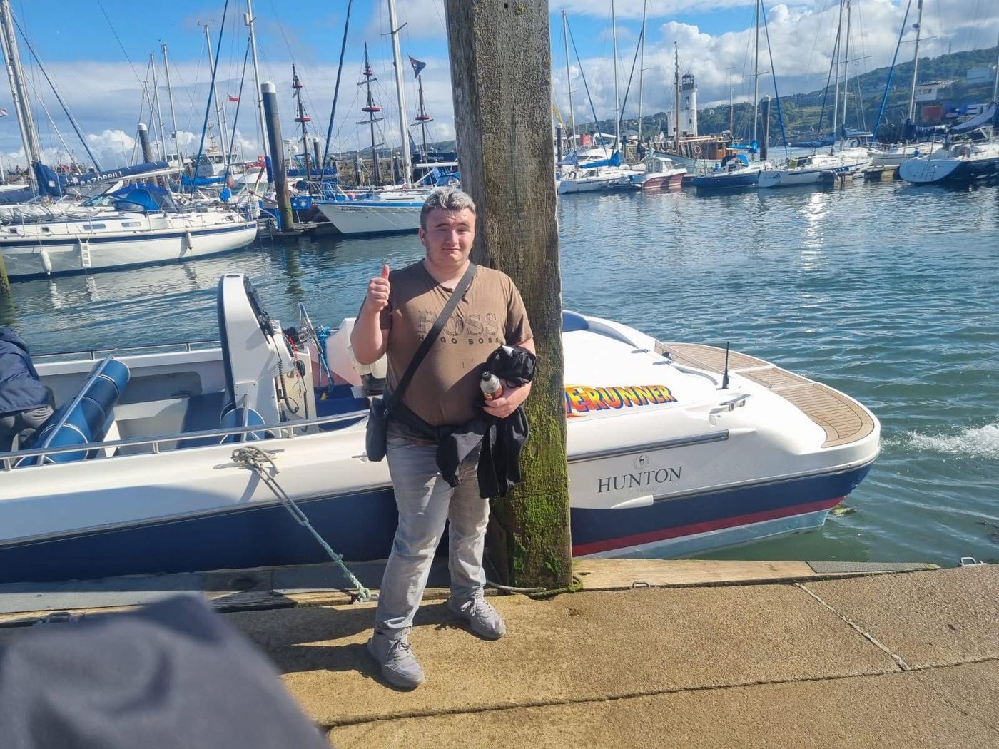 Callum Lamb standing by the boats at the marina